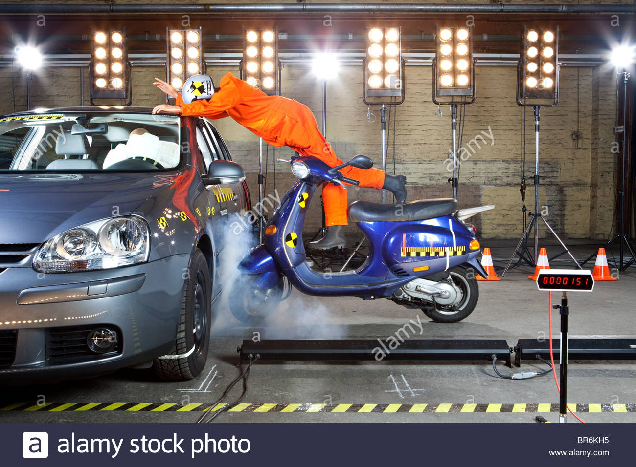 A stock image of a crash test dummy wrecking a scooter into a car